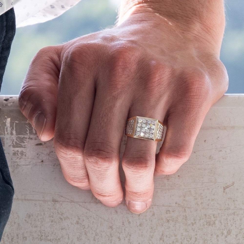 Hand wearing a gold ring with diamonds on a blurred background.