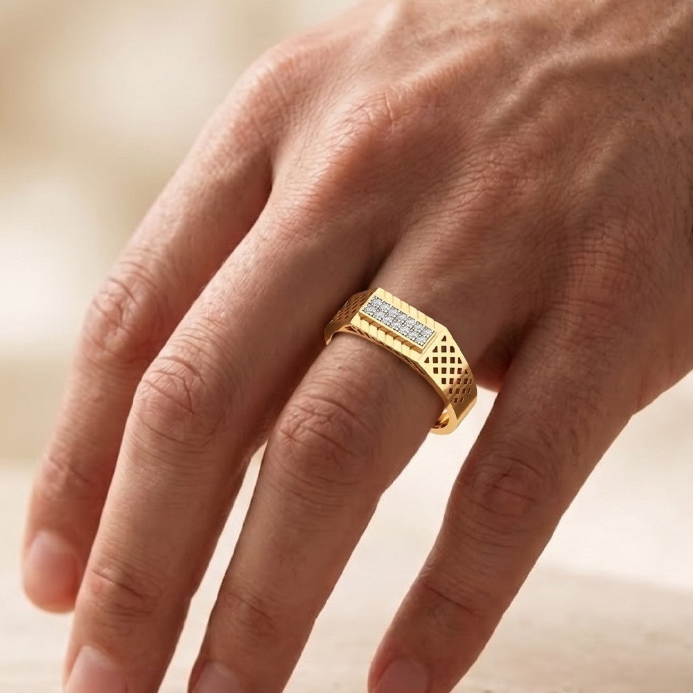 Gold ring with diamonds on a person's finger against a blurred background.