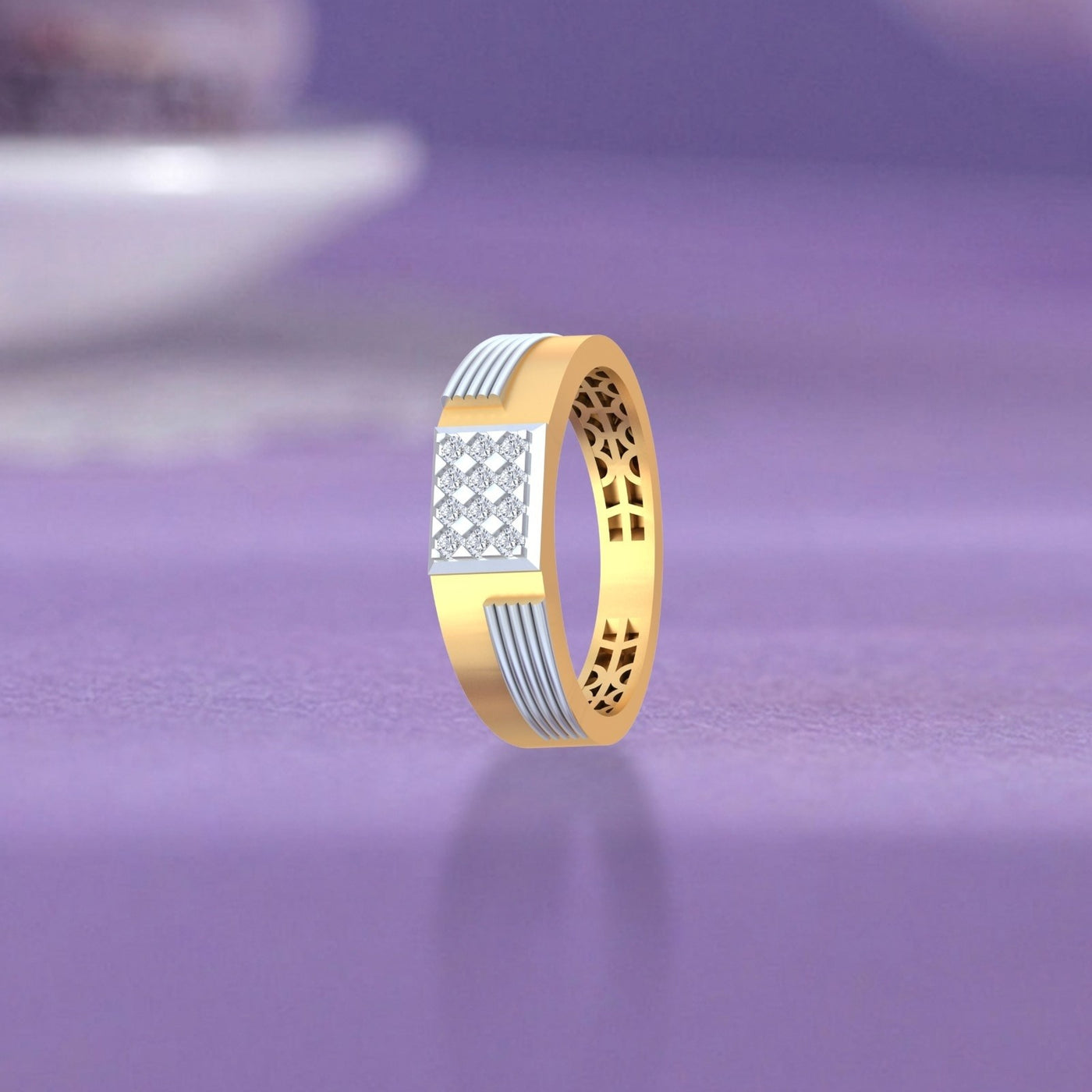Gold and diamond ring with a textured geometric on a purple reflective surface.