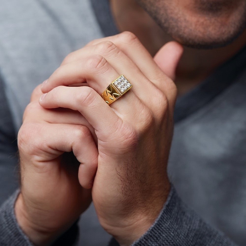 Close-up of a person wearing a gold ring with a diamond on a neutral background