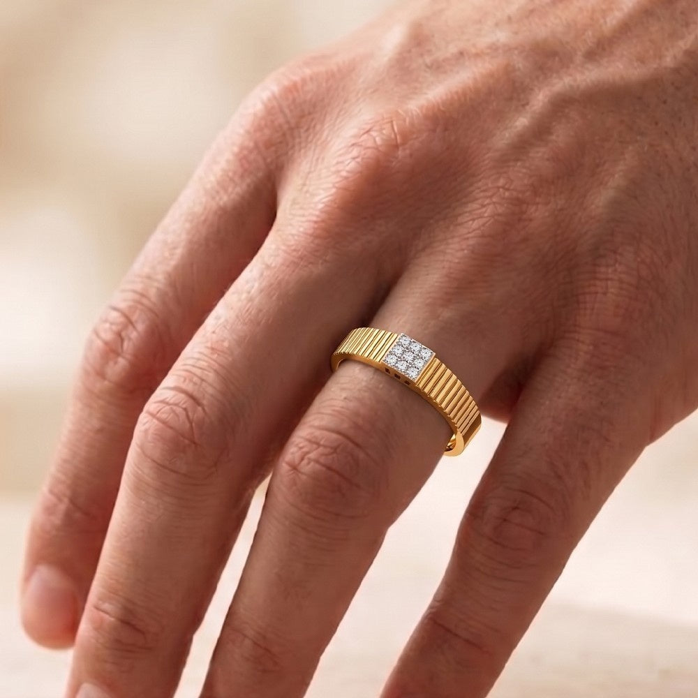 Gold ring with diamonds on a person's finger against a blurred background.