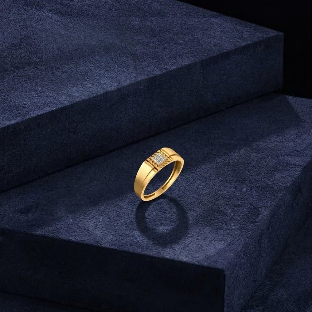 Gold ring with diamonds on a dark blue textured surface.