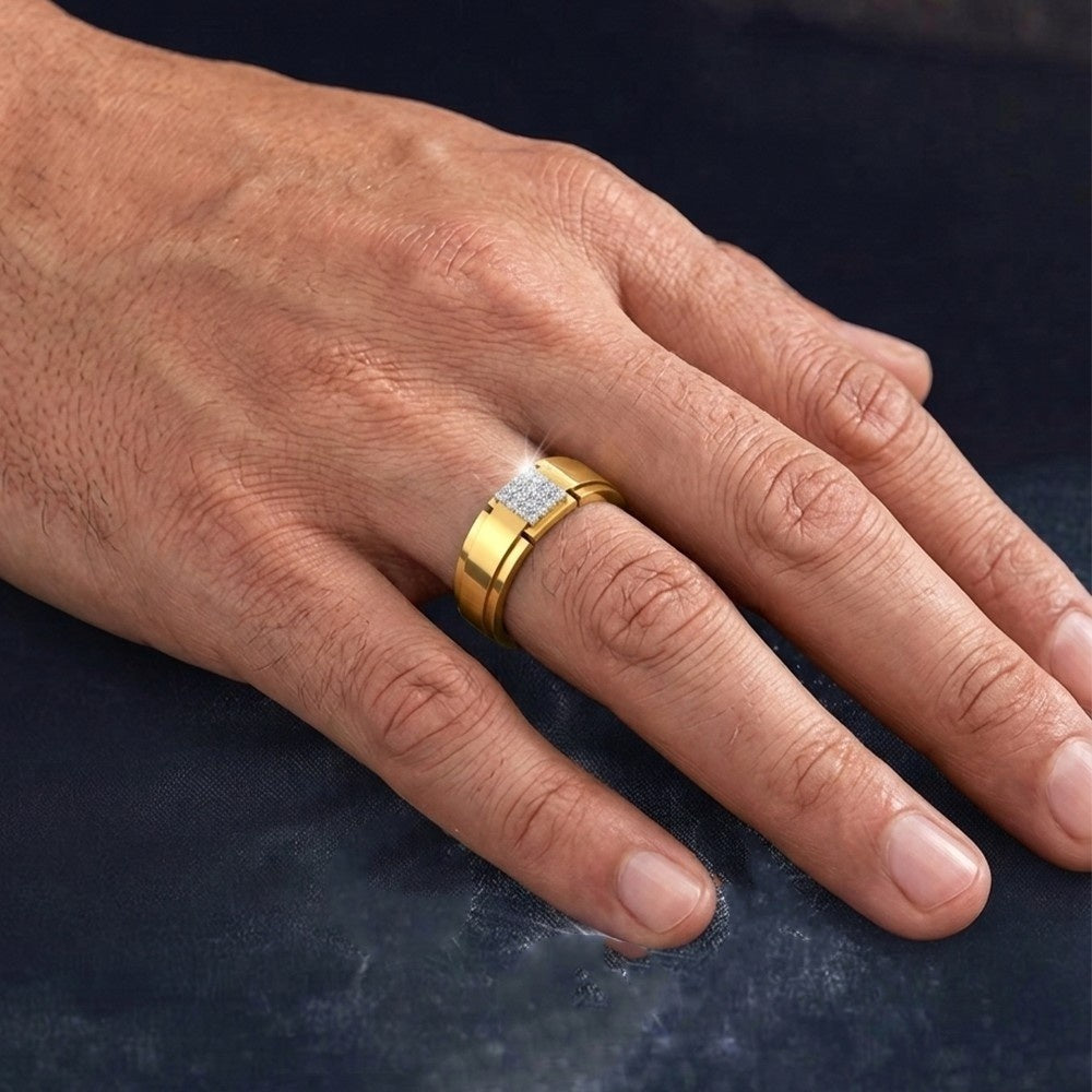 Hand wearing a gold ring with a diamond on a dark background.
