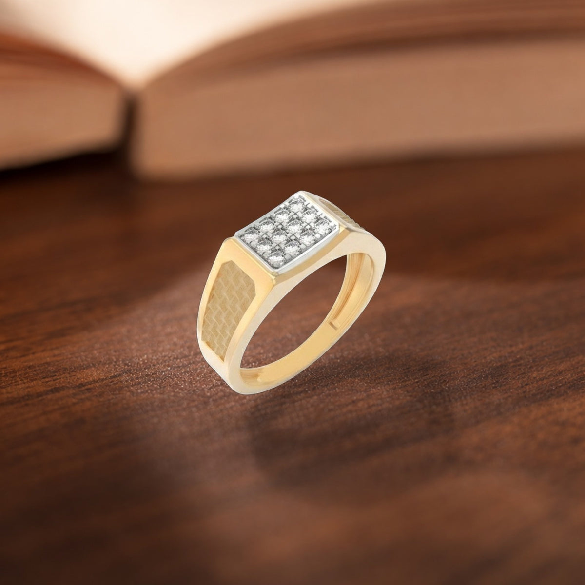 Gold ring with diamond accents on a wooden surface