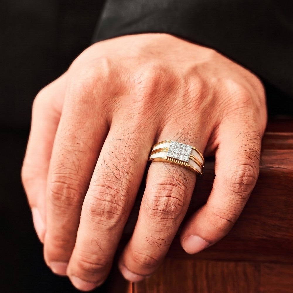 Hand wearing a gold ring with a diamond band on a wooden surface.