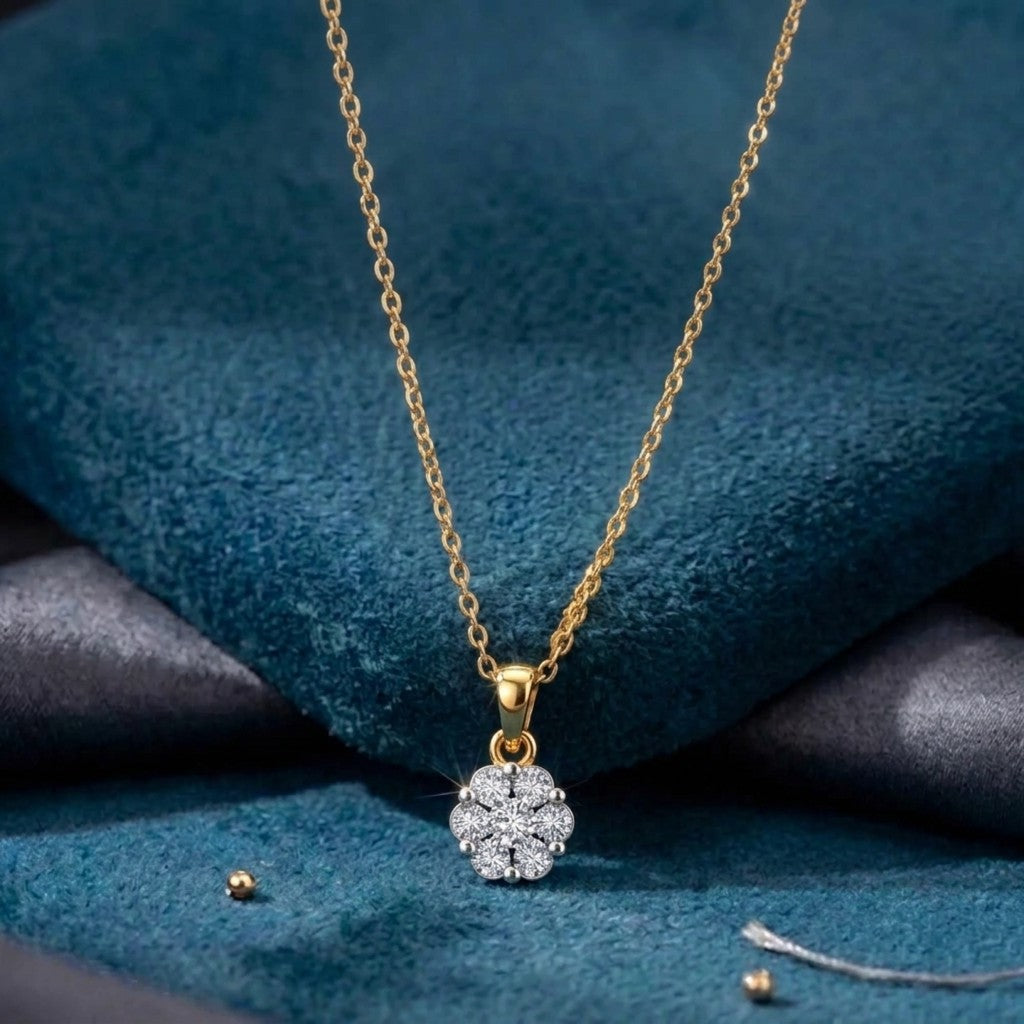 Gold necklace with a diamond pendant on a blue fabric background
